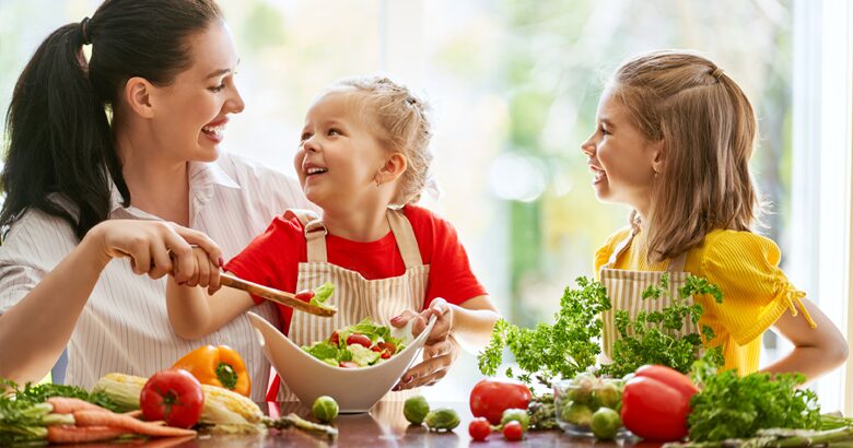 Mom tossing salad with kids