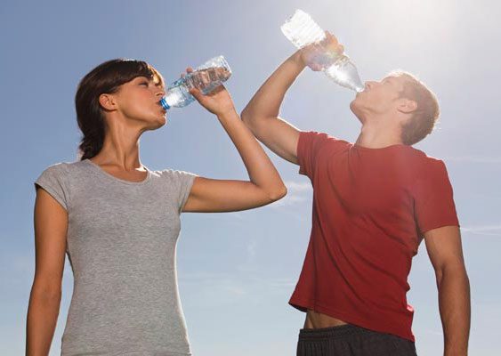 woman and man drinking bottled water